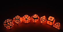 Load image into Gallery viewer, Enchanted Red Metal Dice Set in the dark | 7 piece